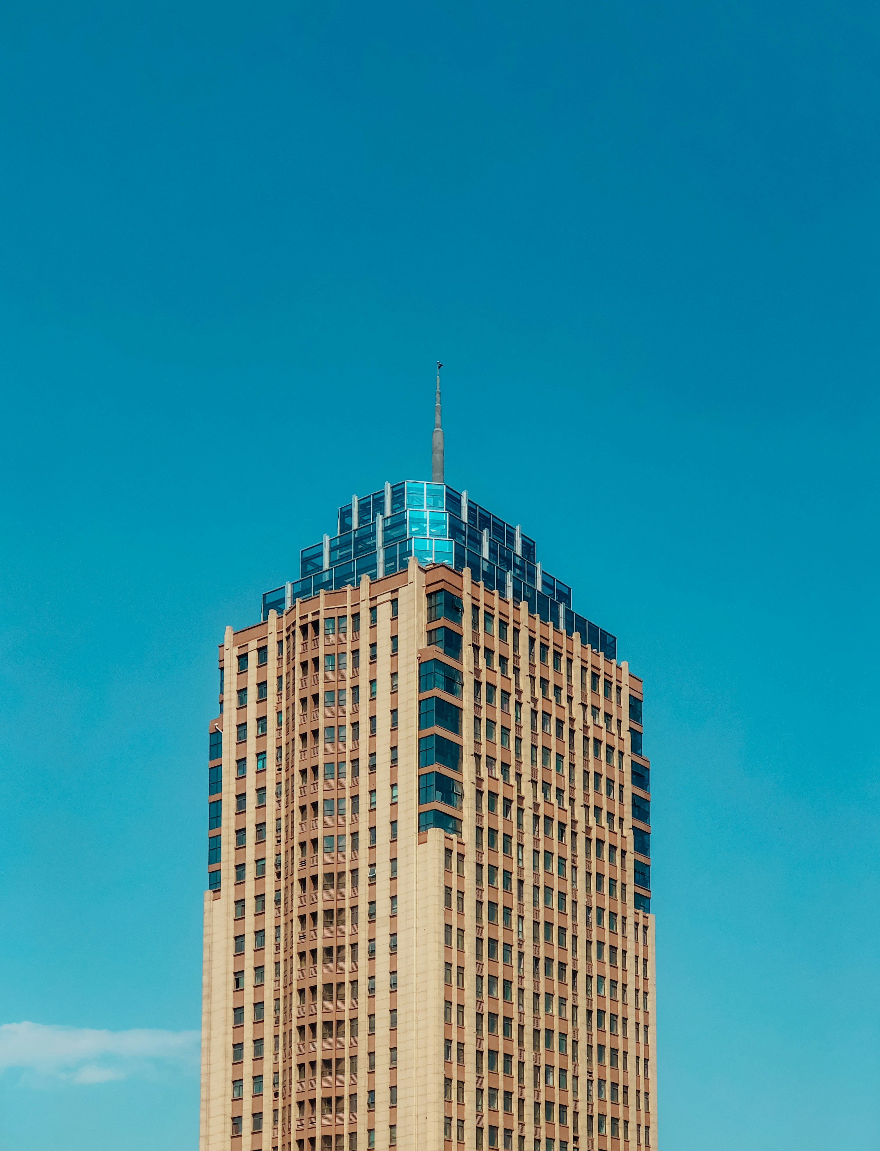 brown and white concrete building under blue sky during daytime